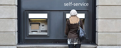Person standing at an ATM