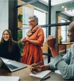 Woman stood up and smiling during meeting